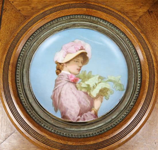 A late 19th century dish painted with a girl, oak frame, 41cm x 42cm